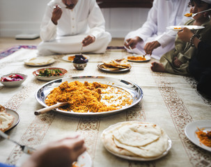 Muslim family having dinner on the floor