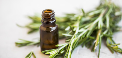 Herbal green rosemary herb essential oil bottle, selective focus
