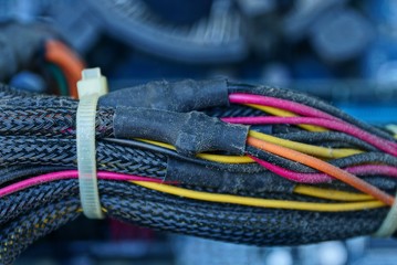 many colored wires and cables in the dust in the computer