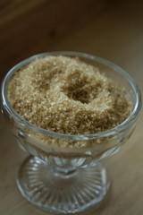 Vintage glass bowl of brown demerara sugar in a cafe