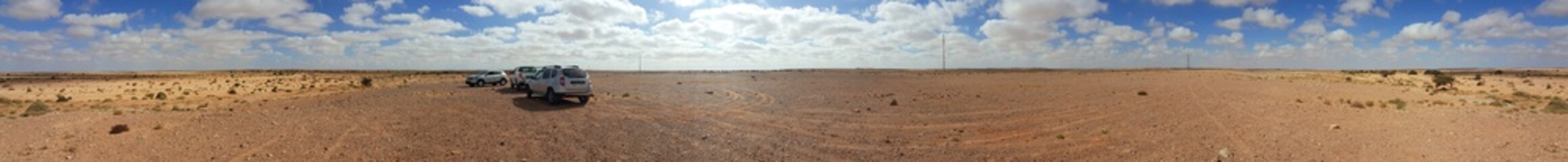 MOROCCO, ES-SMARA - MARCH 26,2018: Sunny day in the desert, morocco; Desert landscape, car standing on off-road desert