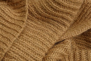 brown texture of a woven piece of cloth made of a sweater