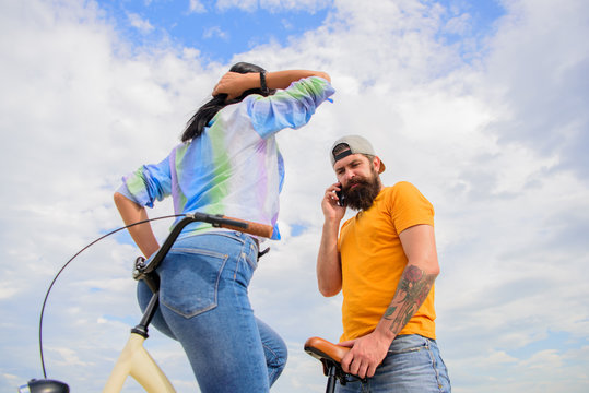 Girl Sit On Handlebar Of His Bike. Man Bearded Hipster Rides Girlfriend On His Bike. Girl Likes He Rides Her On Handlebar. Why Women More Attracted Biker Guys. Women Pay Attention To Bikers