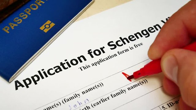 Decision to grant a Schengen Visa. Pen voting approved in checkbox in blank application form with passport and pen. Document with passport, apply and permission for foreigner country