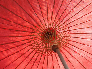 Shadow on a red umbrella