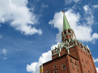 Moscow Kremlin tower with red star against the blue sky with white clouds. Troitskaya tower, russian architecture landmark
