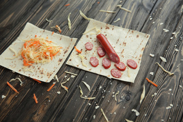 ingredients for cooking burrito on a wooden table