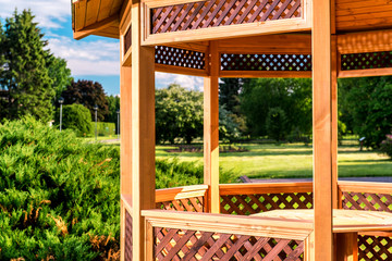 Outdoors wooden gazebo over summer landscape