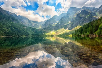 Wall murals Nature Beautiful alpine lake in the mountains, summer landscape with blue cloudy sky and reflection in crystal clear water, natural background, Morske Oko (Eye of the Sea), Tatra Mountains, Zakopane, Poland