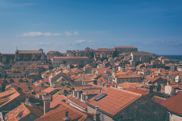 Fototapeta na wymiar Red tiled roofs of Dubrovnik Old Town, view from the ancient city wall. The world famous and most visited historic city of Croatia, UNESCO World Heritage site, vintage image