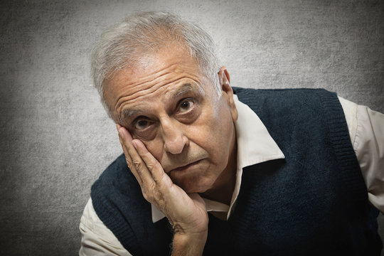 Portrait of a senior man with hand on face