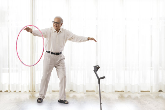 Senior man exercising with hoopla hoop