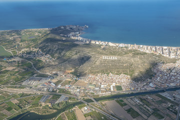 Fototapeta premium Areal view from airplane of Cullera resort village in Valencia region.