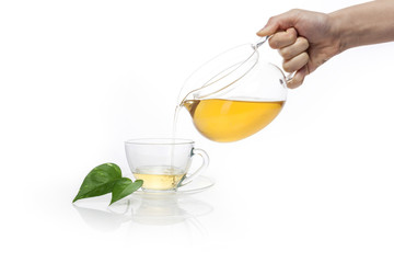 woman hand dropping a green tea isolated white.