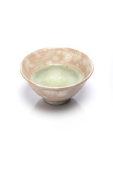 green tea with a ceramic bowl isolated white.