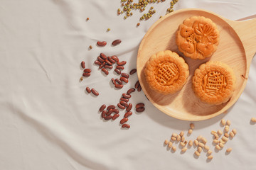 Flat lay conceptual of Mid-autumn Festival food mooncake. Text on cake mean Happiness.