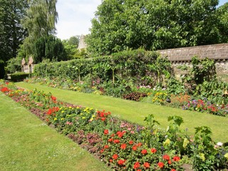 English garden with flowerbeds in bloom