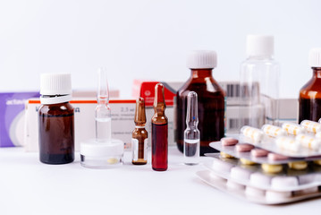 Pharmaceutical colorful pills, capsules, ampoules  on white background