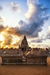 Photo shot on sunrise time where the historical buildings of Mamallapuram monuments are highlighted. 