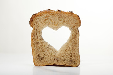 slice of bread with cut heart on a white background
