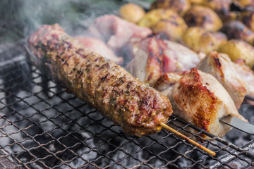 Kebab and pieces of fried meat on a grill. Close up
