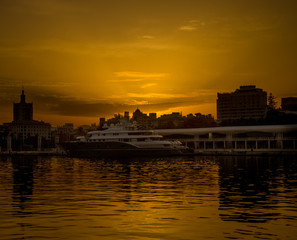 Fototapeta premium Spain, Malaga, a sunset over a body of water
