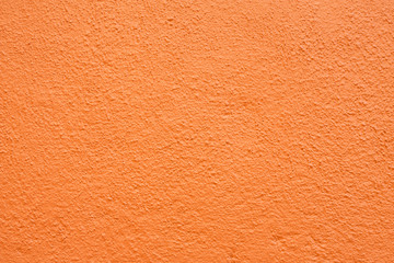 Stucco wall - Orange stucco textured wall background with natural light.