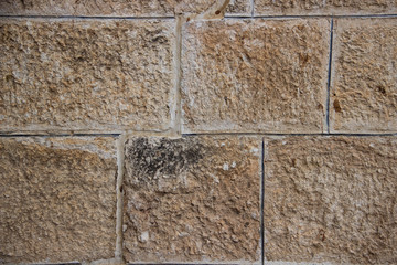 Wall of stones of different shapes of light shades