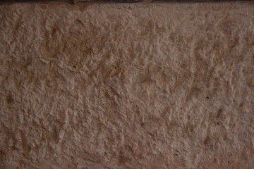 Stone textured wall of gray yellow tones