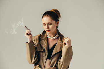 Femme fatale. Portait of a beautiful woman with cigarette