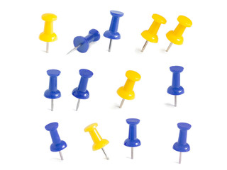 isolated blue and yellow push pins in white background