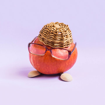 Pumpkin in form of funny little man in hat and glasses