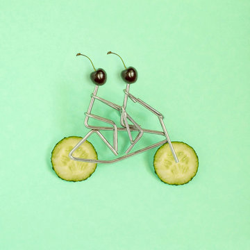 Metal figures of sportsmen on bicycle with cucumber wheels