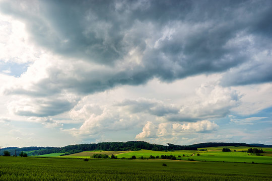 Scenic view of heavy clouds on blue sky background. Photo of approaching storm in summer.