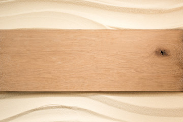 top view of blank wooden plank on sandy surface