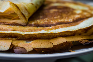 Appetizing golden pancakes with crispy crust, cooked at home. Fatty and hot pancakes on milk