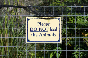 Do not feed animals sign on fence at zoo park
