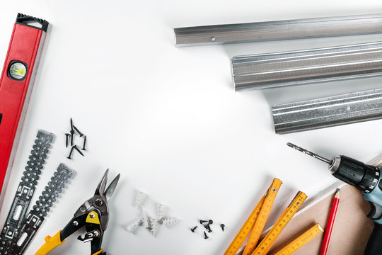 Drywall Mounting Tools And Fasteners On White Background. Top View