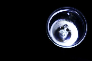 Lamp of incandescence is retro style, transparent and crooked, the background is black.