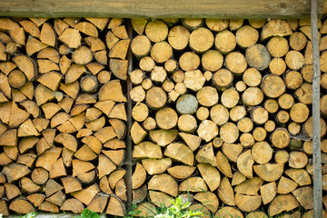 Wall of natural firewood. Stacked Logs Texture.