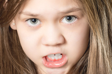 Cute young girl showing teeth