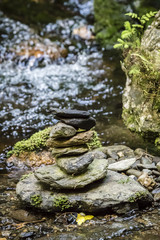 Fototapeta na wymiar Set of stones wearing in the running water of the river.