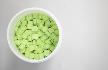 green medicine pills in can top view