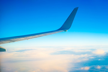 Wing of the plane on blue sky background
