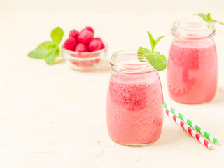 Raspberry smoothie close up photography with fresh summer blended cocktail and ripe berries.