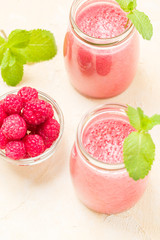 Raspberry smoothie close up photography with fresh summer blended cocktail and ripe berries.