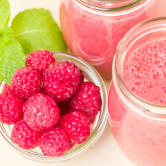 Raspberry smoothie close up photography with fresh summer blended cocktail and ripe berries.