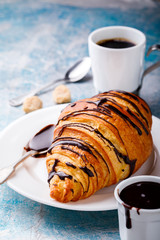   Breakfast Continental  with Fresh  Croissants on a blue Background Coffee  and milk Delicious Baking with  with Chocolate Topping