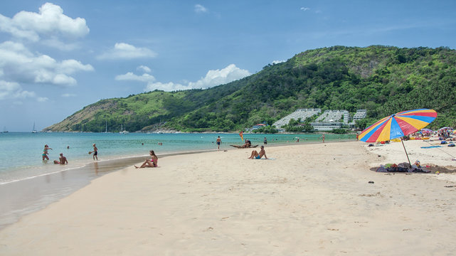 Tourists on the Nai Harn beach - one of the best beaches in Phuket, Thailand 