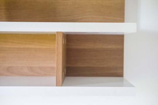 Wooden shelf for product on shelf.